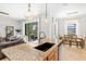 Modern kitchen with granite countertops, pendant lights, and an open design flowing into the dining and living areas at 13112 Swiftwater Way, Bradenton, FL 34211
