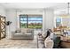 Inviting living room with sofas, a ceiling fan, and a view of the outdoor pool at 13112 Swiftwater Way, Bradenton, FL 34211