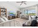 Comfortable living room with a large window overlooking a pond and outdoor pool at 13112 Swiftwater Way, Bradenton, FL 34211