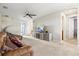 Spacious living room with a ceiling fan, carpet flooring, comfortable seating, and entertainment center at 13112 Swiftwater Way, Bradenton, FL 34211