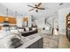 Open-concept living room connects to the kitchen and features stylish seating and natural light at 13112 Swiftwater Way, Bradenton, FL 34211