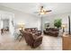 Inviting living room with a neutral color palette, tile floors, and comfortable reclining furniture at 13112 Swiftwater Way, Bradenton, FL 34211