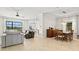 Open-concept living and dining area with tiled floors and large windows at 13112 Swiftwater Way, Bradenton, FL 34211