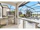 Outdoor kitchen featuring stainless steel appliances, granite countertops, and convenient access to a screened-in pool area at 13112 Swiftwater Way, Bradenton, FL 34211