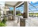 Well-equipped outdoor kitchen with stainless steel appliances, granite countertops, and access to a pool in a screened enclosure at 13112 Swiftwater Way, Bradenton, FL 34211