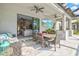 Covered outdoor patio featuring comfortable seating, a ceiling fan, a television, and access to indoor living spaces at 13112 Swiftwater Way, Bradenton, FL 34211