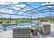 Gorgeous screened-in pool area featuring a spa, sun loungers, and comfortable patio seating with basketball hoop nearby at 13112 Swiftwater Way, Bradenton, FL 34211