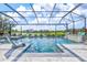 Stunning screened-in pool area features a serene waterfront view, a spa, and luxurious lounging chairs at 13112 Swiftwater Way, Bradenton, FL 34211