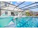 Inviting view of the sparkling pool and spa area from a covered patio, complete with a stylish waterfall feature at 13112 Swiftwater Way, Bradenton, FL 34211