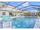 Beautiful, screened-in pool with a waterfall feature, complemented by an open patio and comfortable seating at 13112 Swiftwater Way, Bradenton, FL 34211