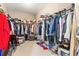 Spacious walk-in closet with an extensive wardrobe, providing ample storage space for clothing and accessories at 13112 Swiftwater Way, Bradenton, FL 34211