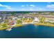 This is an aerial view of the community's lake with commercial buildings, restaurants, and condos at 13169 Steinhatchee Loop, Venice, FL 34293