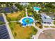 Aerial view of splash pad, picnic shelters, lush landscaping, and convenient parking in a Gathering-friendly community at 13169 Steinhatchee Loop, Venice, FL 34293