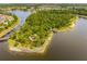 Aerial view of lake, walking paths, and community areas surrounded by lush greenery at 13169 Steinhatchee Loop, Venice, FL 34293