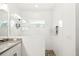 Contemporary bathroom with white tile shower, quartz countertop, and modern lighting at 13169 Steinhatchee Loop, Venice, FL 34293