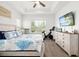 Light-filled bedroom with coastal-themed decor, wood-look floors, and modern amenities for comfortable living at 13169 Steinhatchee Loop, Venice, FL 34293