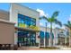 Oak & Stone commercial building with large windows, awnings, and landscaping with palms at 13169 Steinhatchee Loop, Venice, FL 34293