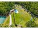 Aerial view of a spacious dog park with play equipment, shaded areas, and secure fencing at 13169 Steinhatchee Loop, Venice, FL 34293