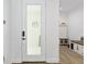 Bright entryway featuring tiled floors, a glass door, and coat rack with bench seating at 13169 Steinhatchee Loop, Venice, FL 34293