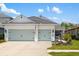Charming home with a three-car garage, beautiful landscaping, and a welcoming front porch, offering curb appeal at 13169 Steinhatchee Loop, Venice, FL 34293