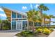 The Banyan House has a yellow-painted exterior, a sloped roof, and multiple palm trees in the landscaping at 13169 Steinhatchee Loop, Venice, FL 34293