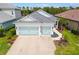 Charming single-Gathering home featuring a driveway, attached garage, and lovely landscaping at 13169 Steinhatchee Loop, Venice, FL 34293