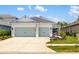 Charming home featuring a two-car garage, well-manicured lawn, and eye-catching curb appeal at 13169 Steinhatchee Loop, Venice, FL 34293