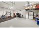 Spacious garage with ample storage solutions, including shelving and wall-mounted racks for organization at 13169 Steinhatchee Loop, Venice, FL 34293