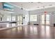 Spacious gym with mirrors, windows, ample workout space, and fitness equipment at 13169 Steinhatchee Loop, Venice, FL 34293