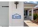 Close-up of the house number 13169 on a white exterior wall with a view of the cozy front porch at 13169 Steinhatchee Loop, Venice, FL 34293