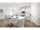 Bright kitchen with a large island, white cabinetry, modern appliances, and a cozy breakfast nook at 13169 Steinhatchee Loop, Venice, FL 34293