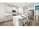 Modern kitchen with white cabinetry, stainless steel appliances, a large island, and pendant lighting at 13169 Steinhatchee Loop, Venice, FL 34293