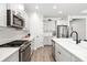 Well-equipped kitchen featuring stainless steel appliances, white cabinetry, and a stylish backsplash at 13169 Steinhatchee Loop, Venice, FL 34293