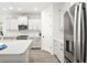 Modern kitchen with white cabinetry, stainless steel appliances, and a stylish backsplash at 13169 Steinhatchee Loop, Venice, FL 34293