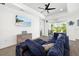 Relax in the living room featuring shiplap walls and a mounted tv, with a clear view of the screened-in lanai at 13169 Steinhatchee Loop, Venice, FL 34293