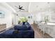 Living room with seamless transition into the kitchen and dining area, perfect for entertaining guests at 13169 Steinhatchee Loop, Venice, FL 34293