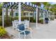 A shaded outdoor seating area with blue-and-white awnings and comfortable chairs at 13169 Steinhatchee Loop, Venice, FL 34293