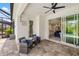 Covered patio featuring a ceiling fan, comfortable seating and sliding glass doors leading to the pool at 13169 Steinhatchee Loop, Venice, FL 34293