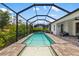 Relaxing pool area with a sun shelf and a screened enclosure offering views of the surrounding greenery at 13169 Steinhatchee Loop, Venice, FL 34293
