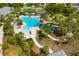 Aerial view of resort pool with a slide, lounging areas, and tropical landscaping at 13169 Steinhatchee Loop, Venice, FL 34293