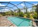 Refreshing pool with a waterfall feature and screened enclosure, perfect for outdoor enjoyment and relaxation at 13169 Steinhatchee Loop, Venice, FL 34293
