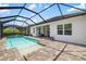 Sparkling pool and spa area, surrounded by a screened enclosure and a paved patio with ample space at 13169 Steinhatchee Loop, Venice, FL 34293
