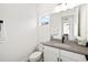 Chic powder room with modern fixtures, a white vanity, and a decorative mirror at 13169 Steinhatchee Loop, Venice, FL 34293