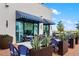 Outdoor restaurant seating with blue and white striped awnings, potted plants, and stylish decor at 13169 Steinhatchee Loop, Venice, FL 34293