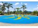 Community splash pad with palm tree water fountains on a blue non-slip surface at 13169 Steinhatchee Loop, Venice, FL 34293