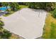 Aerial view of a beach volleyball court with pristine sand and net, surrounded by lush greenery at 13169 Steinhatchee Loop, Venice, FL 34293