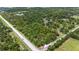 Aerial view of a wooded corner parcel, with lush trees and paved road access at 140 Cowpen Ln, Sarasota, FL 34240