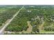 Expansive aerial view of a lush, tree-lined property with potential homesites and a country road at 140 Cowpen Ln, Sarasota, FL 34240