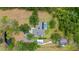 Aerial view of the home showing its pool, solar panels, outbuildings, and privacy on a large lot at 140 Cowpen Ln, Sarasota, FL 34240