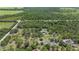 Aerial view of custom home with a pool nestled among lush trees and landscaping at 140 Cowpen Ln, Sarasota, FL 34240